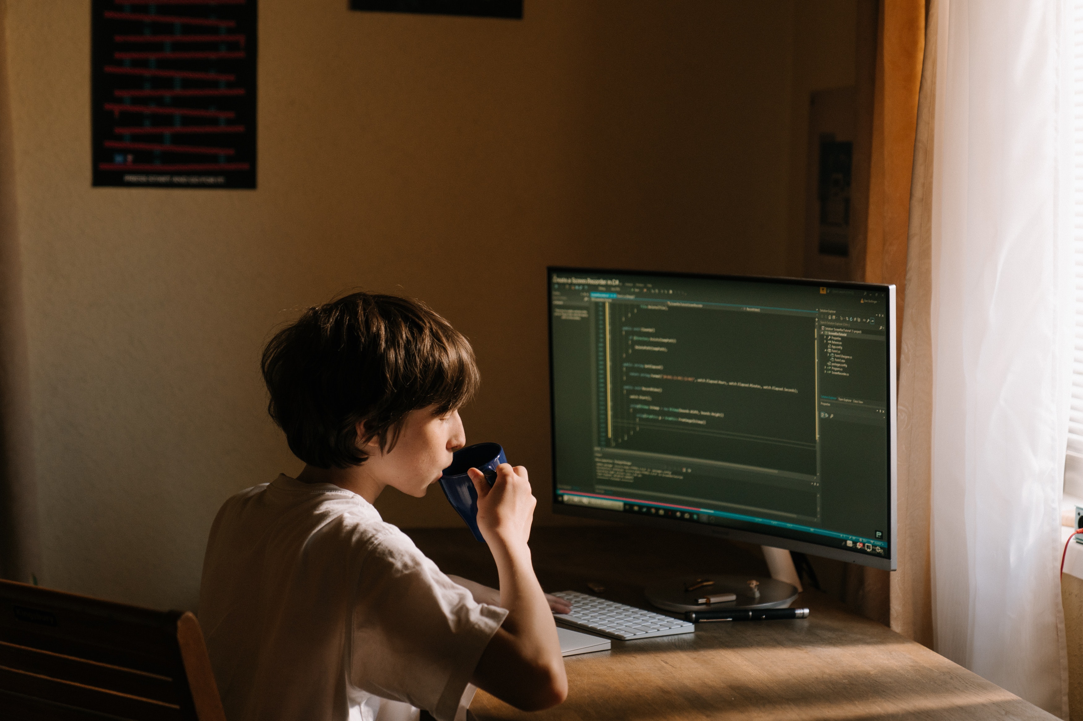 photo of boy learning to code